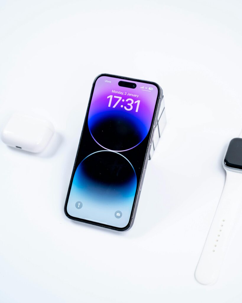 Showcase of a smartphone and smartwatch on a white surface, emphasizing modern technology.